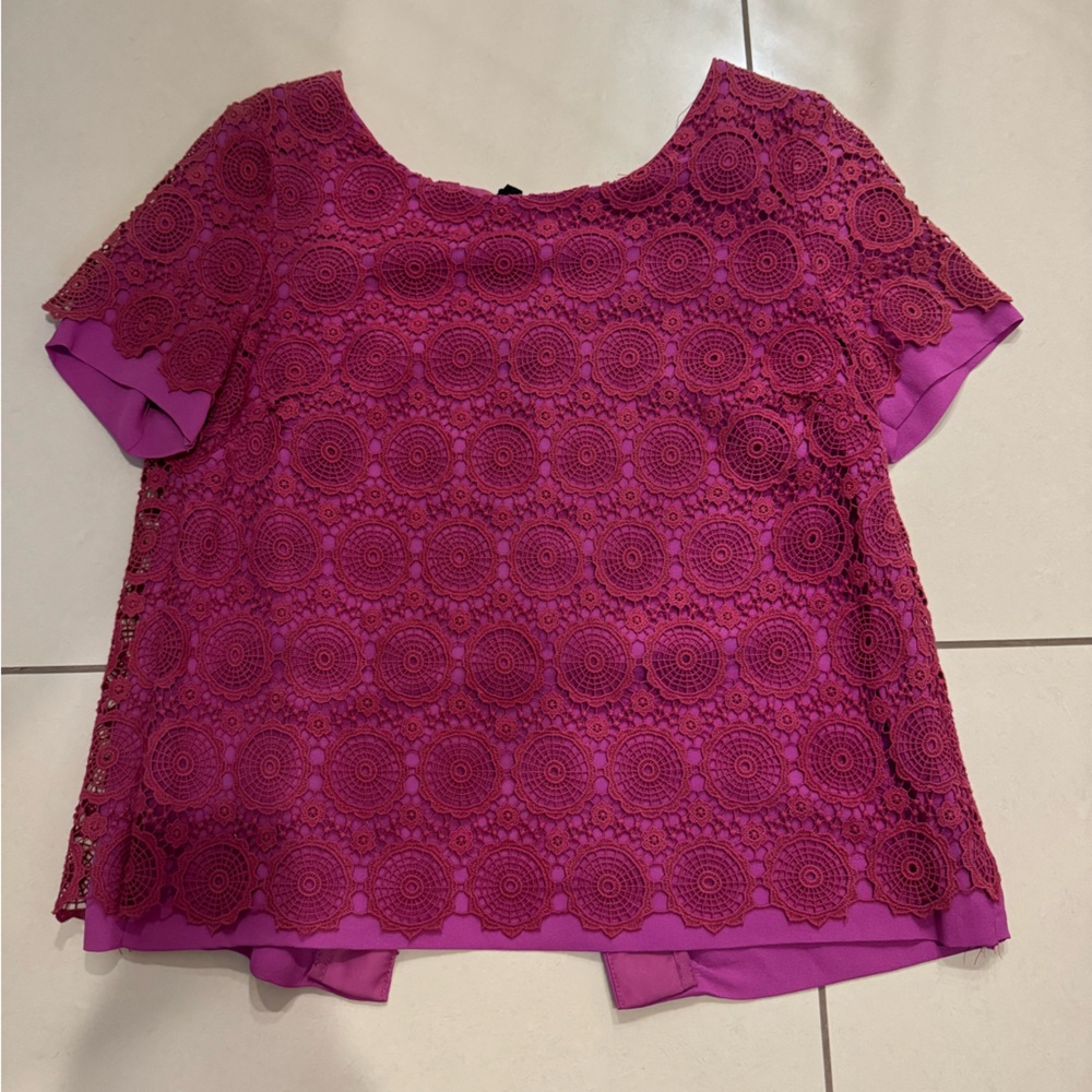 Hot pink lace/ embroidered top with black ties in the black.